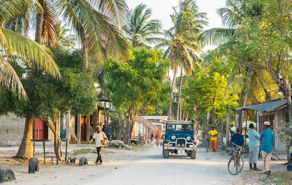 Driving Zanzibar coastal road with mobile signal for navigation